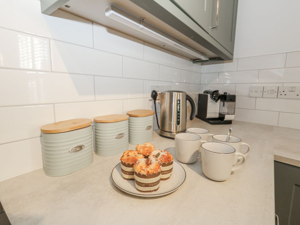 A kitchen with kettles, canisters and cupcakes at Betty's Buoy in Weymouth