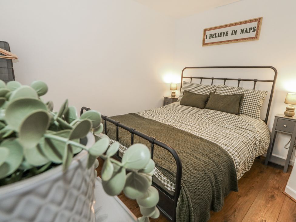 A bedroom with a bed and bedside tables at Betty's Buoy in Weymouth