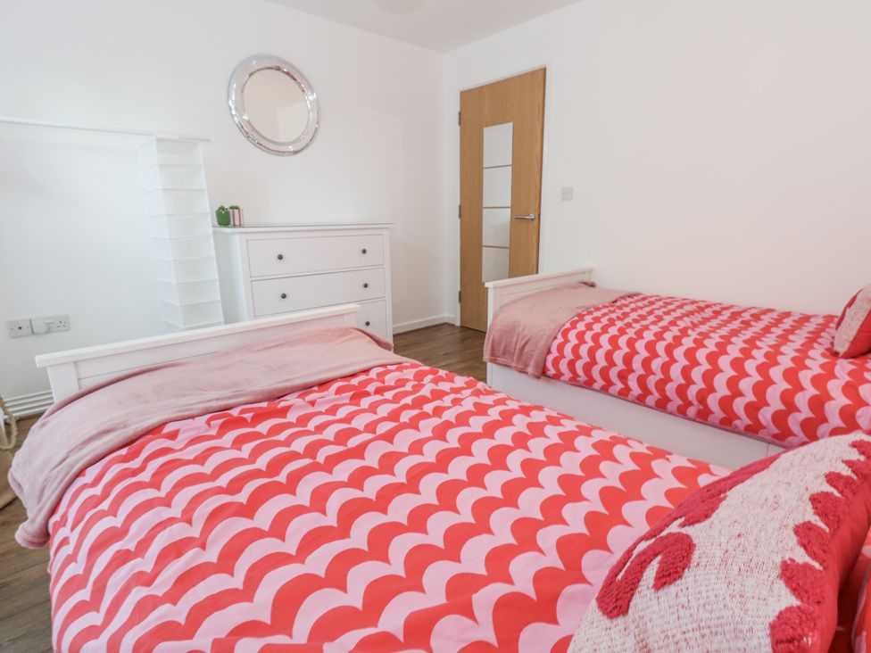 A bedroom with two beds and a dresser at Betty's Buoy in Weymouth