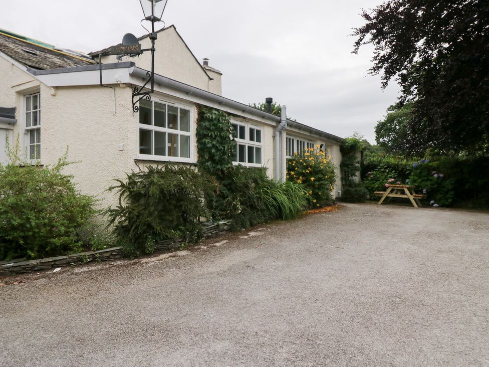 A house exterior with garden and seating area at Pippins Ambleside