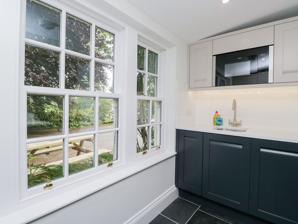 A kitchen with a sink and a microwave at Pippins in Ambleside