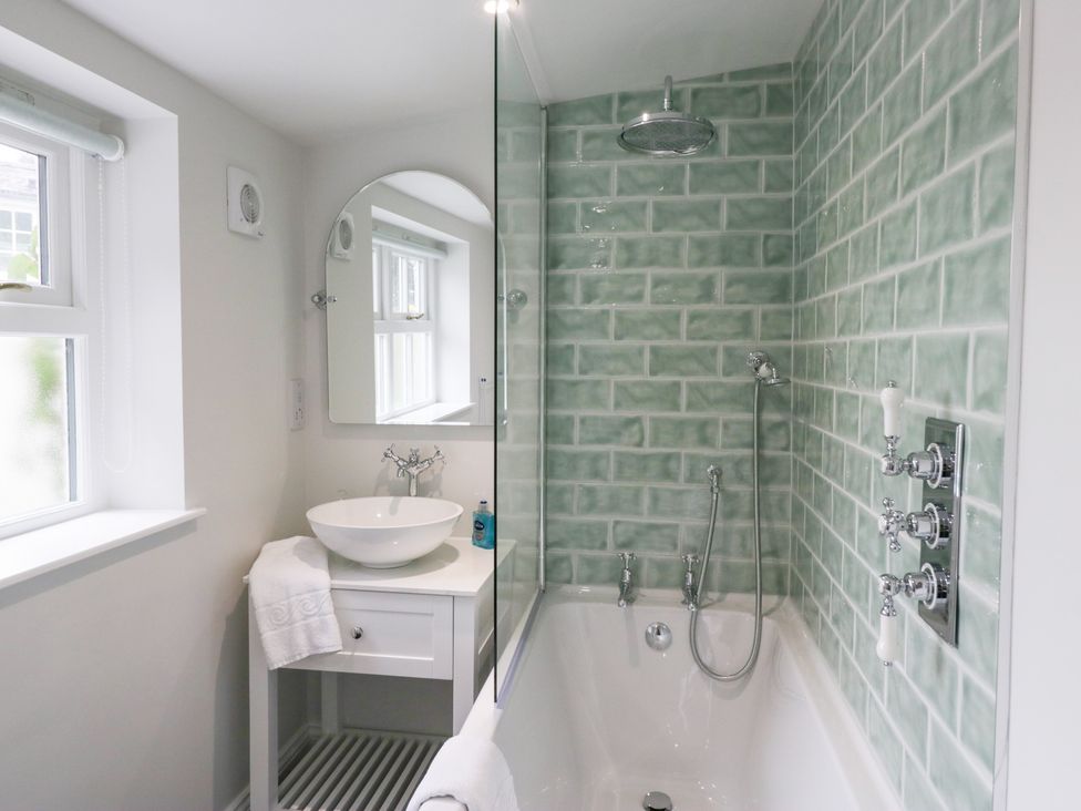 A bathroom with a bathtub and sink at Pippins in Ambleside