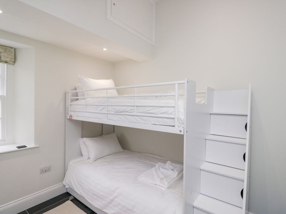 A bedroom with a bunk bed and a bottom bed at Pippins in Ambleside