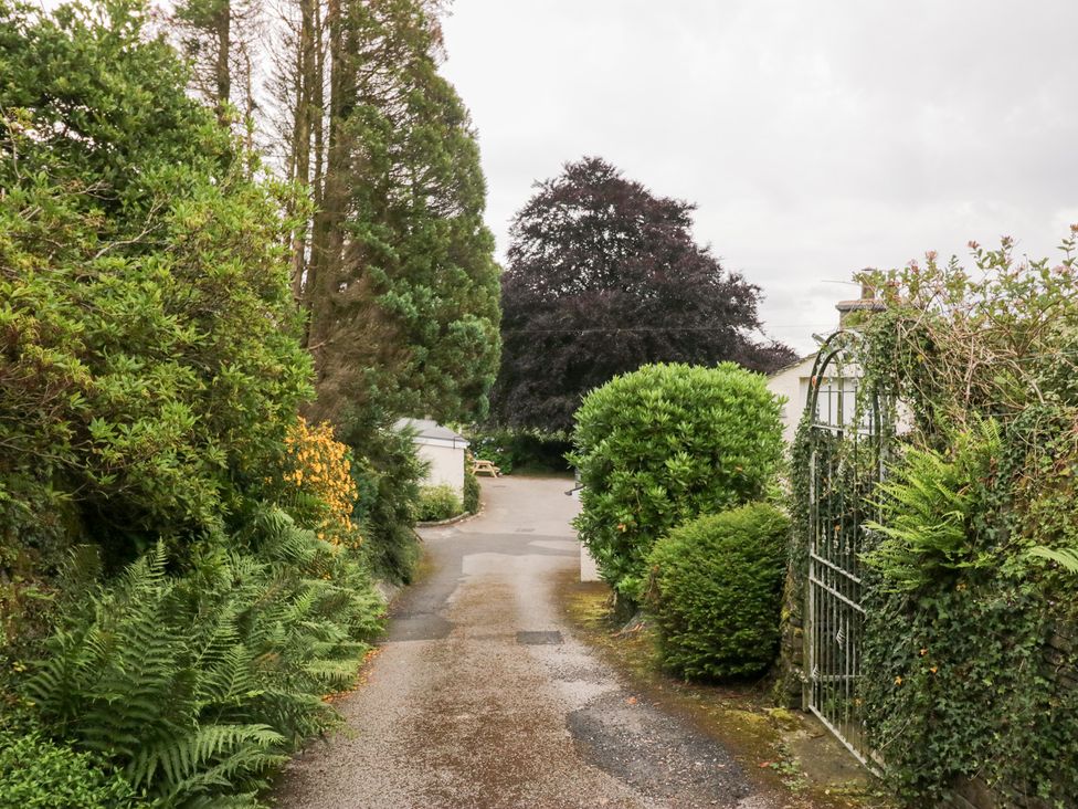 A pathway surrounded by bushes and trees at Pippins in Ambleside