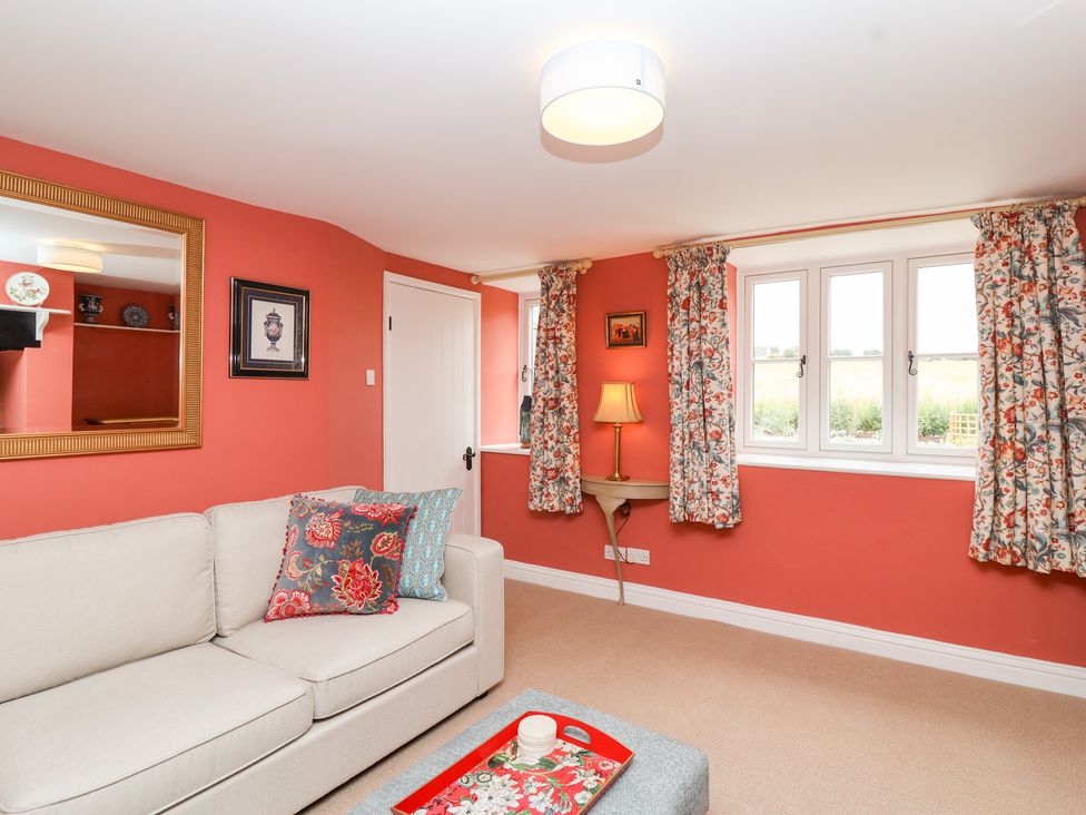 A snug with a sofa and window at Thatchers End in Sherborne