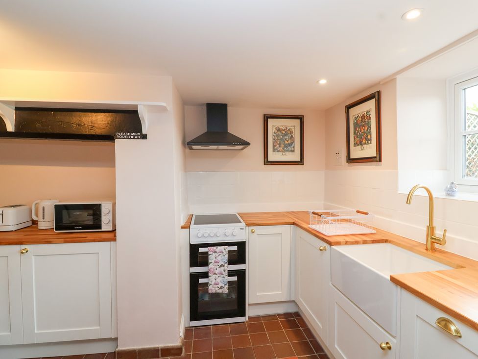 A kitchen with appliances and a sink at Thatchers End in Sherborne