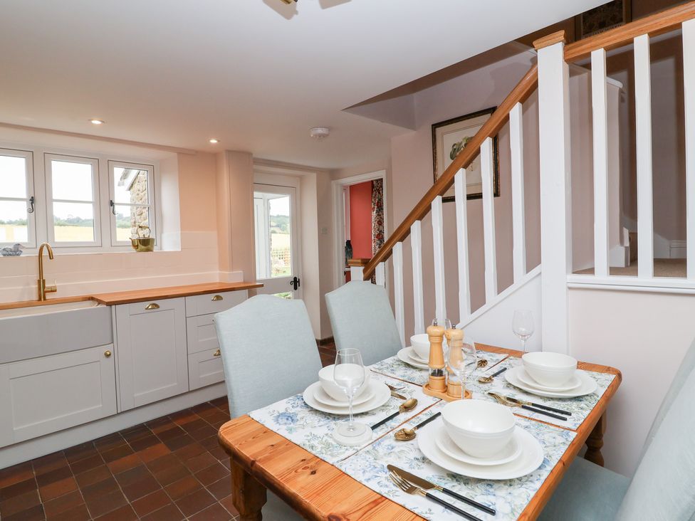 A kitchen with dining table and chairs at Thatchers End in Sherborne