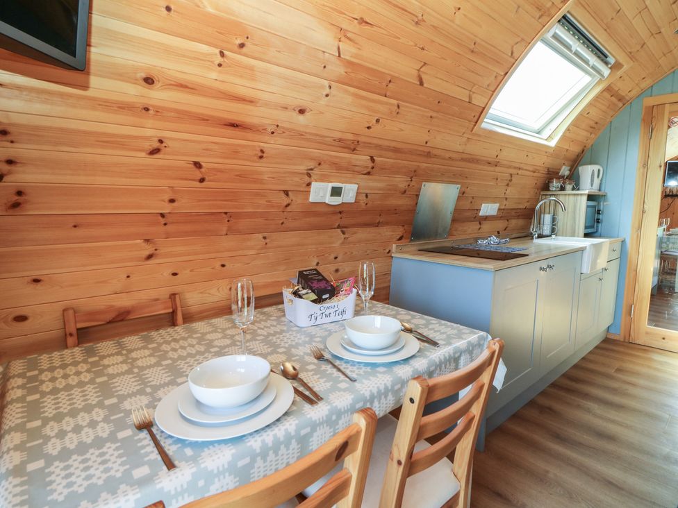 A dining room with a table set for two at Ty Twt Teifi in Tregaron