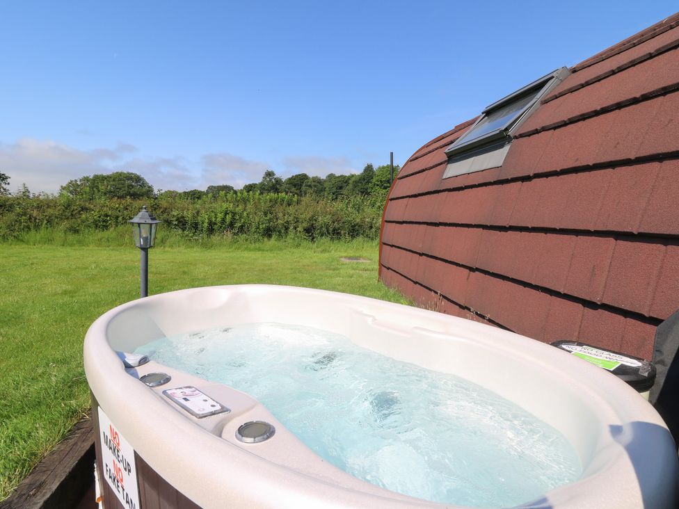 A hot tub in an outdoor space at Ty Twt Teifi in Tregaron
