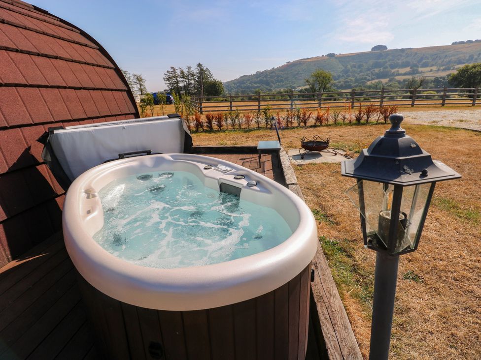 A hot tub on wooden decking at Ty Twt Teifi in Llanddewi-Brefi