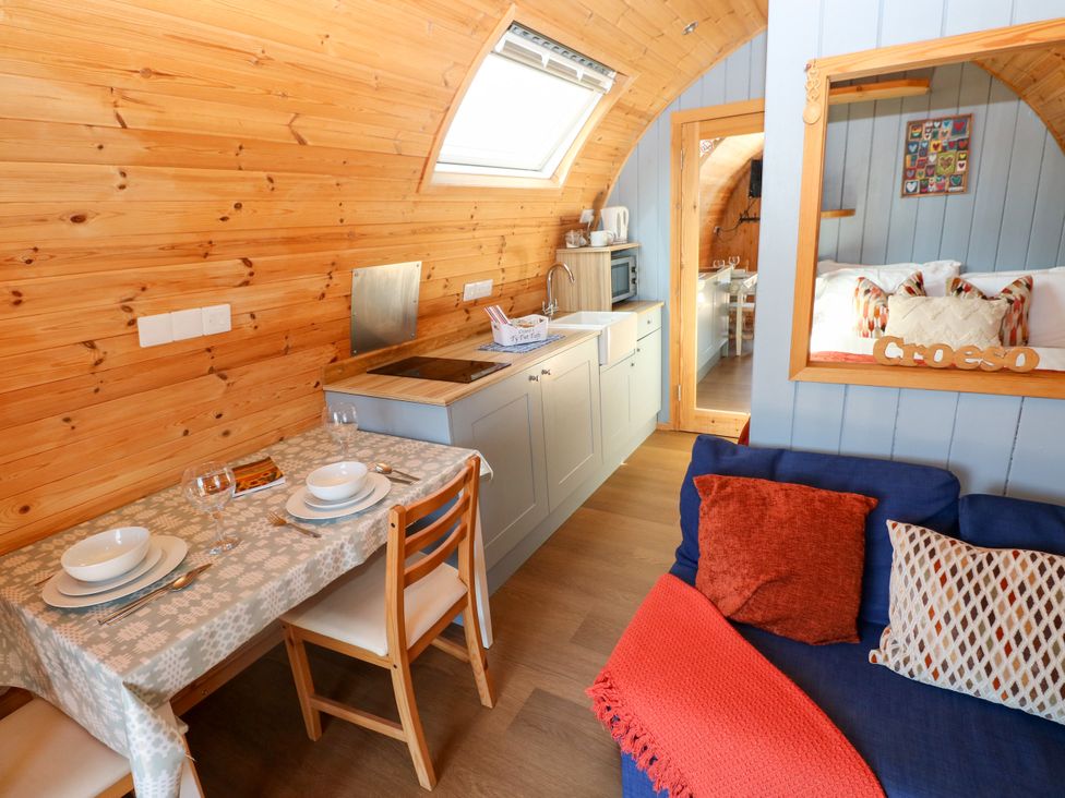 A kitchen with dining table and chairs at Ty Twt Teifi in Llanddewi-Brefi
