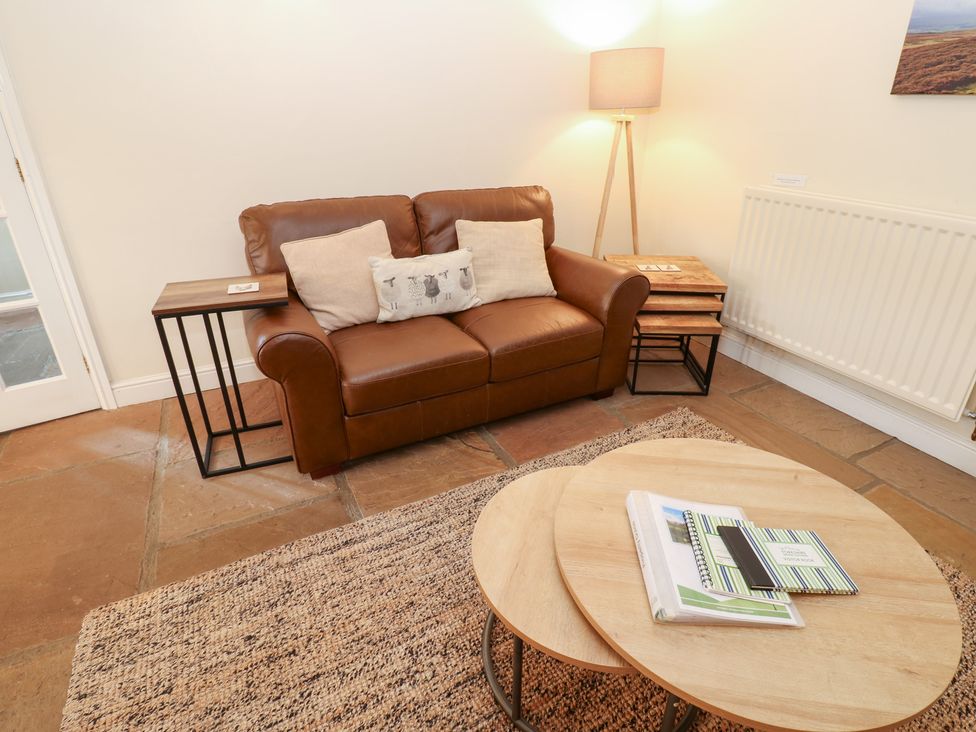 A living room with a sofa and coffee table at Nick Jone in Richmond