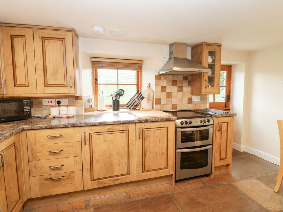 A kitchen with cabinets and appliances at Nick Jone in Richmond