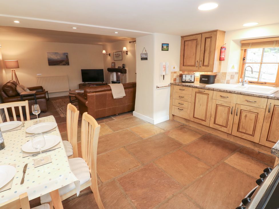 A kitchen with dining area and seating at Nick Jone in Richmond