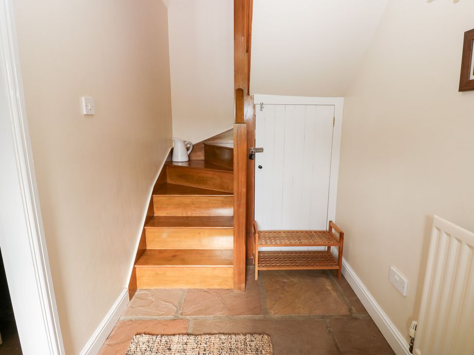A hallway with stairs and a white door at Nick Jone in Richmond