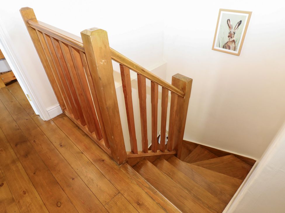 A staircase with wooden railing and a picture at Nick Jone in Richmond