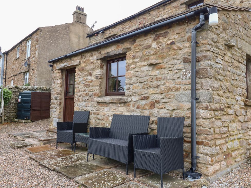 An outdoor area with chairs and stone wall at Nick Jone in Richmond