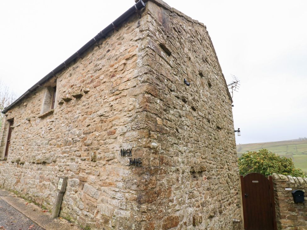 A stone exterior wall of a property with a gate at Nick Jone in Richmond