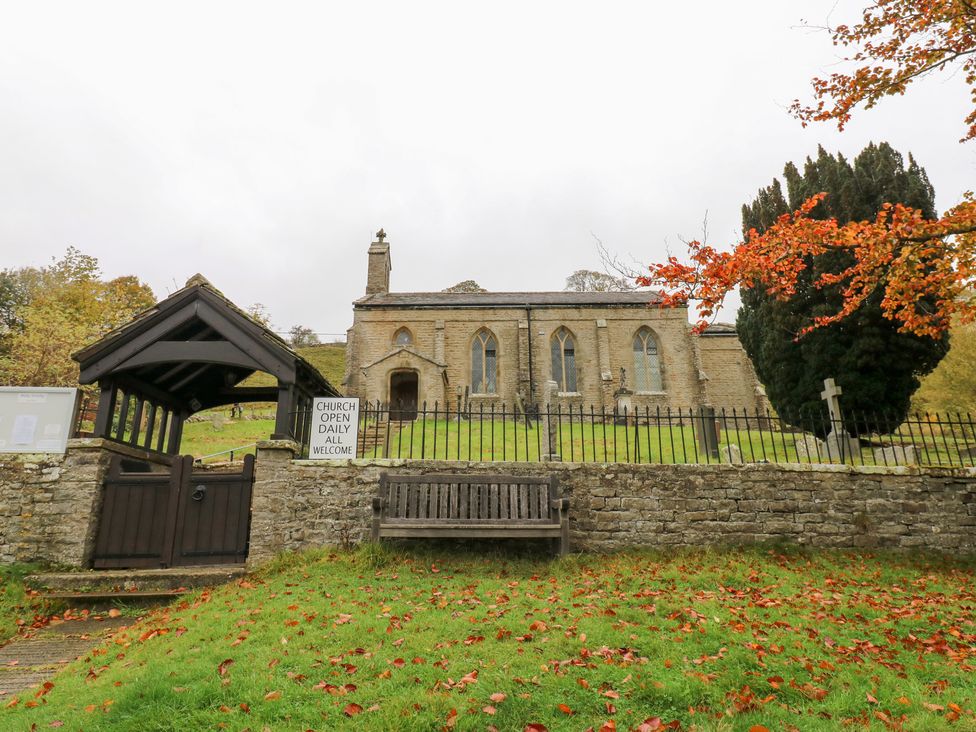 A church with a sign and bench in front at Nick Jone in Richmond