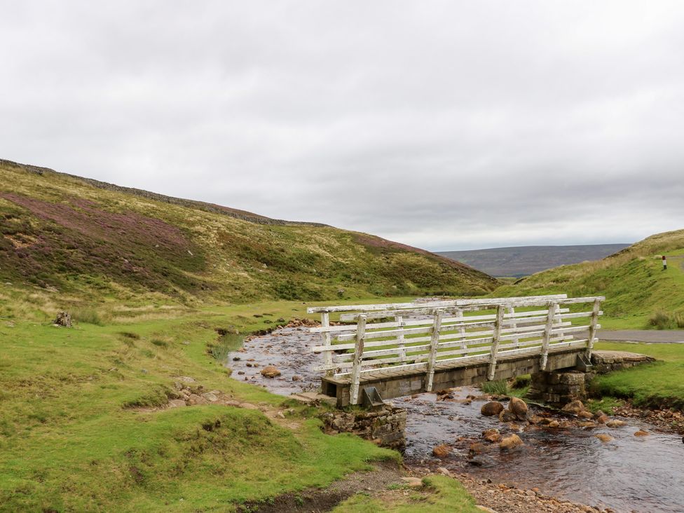 A bridge over a stream in a landscape at Nick Jone in Richmond