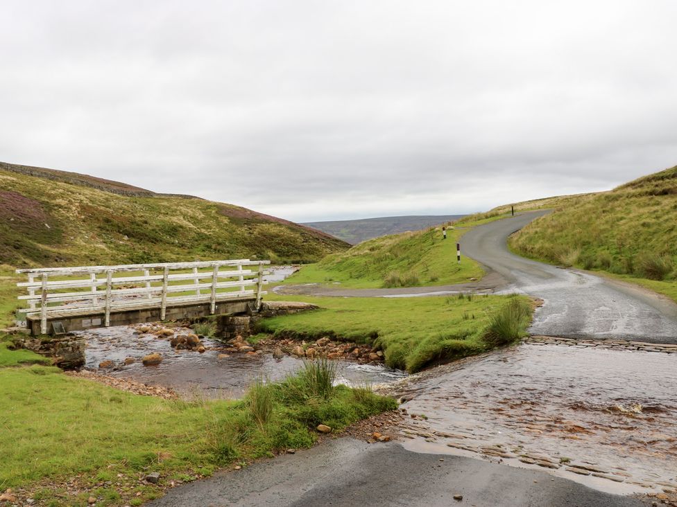 A bridge over a stream with a winding road at Nick Jone in Richmond