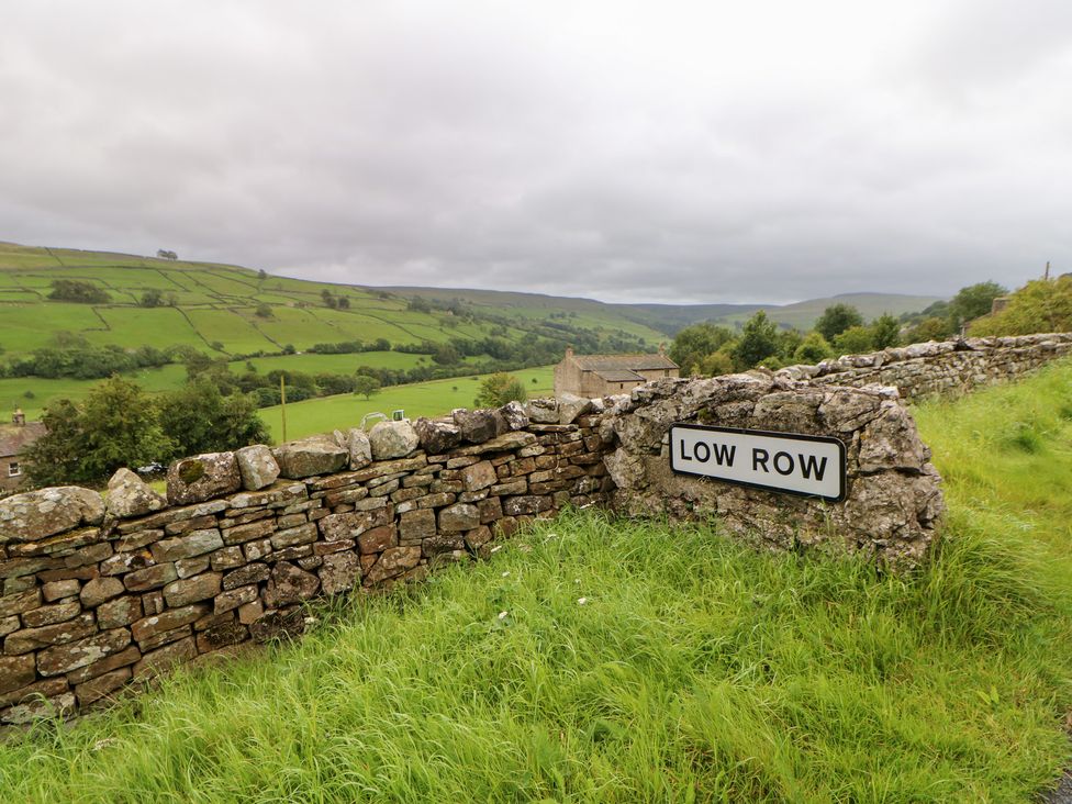 A view of the Low Row sign near a stone wall at Nick Jone in Richmond