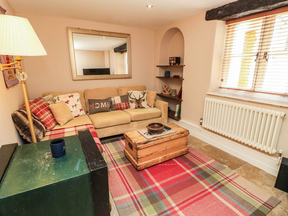 A living room with a sofa and coffee table at Beam Cottage in Warsash