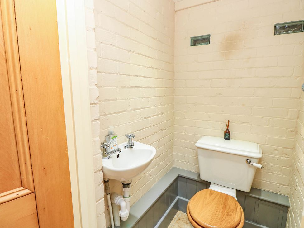 A bathroom with a sink and toilet at Beam Cottage in Warsash