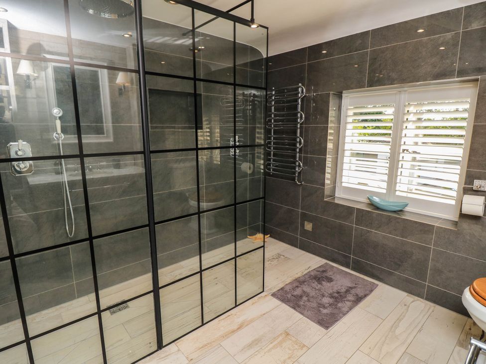 A bathroom with a shower and toilet at Beam Cottage in Warsash