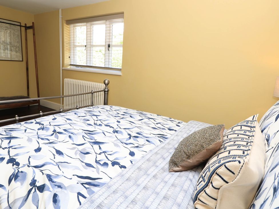 A bedroom with a bed and window at Beam Cottage Warsash