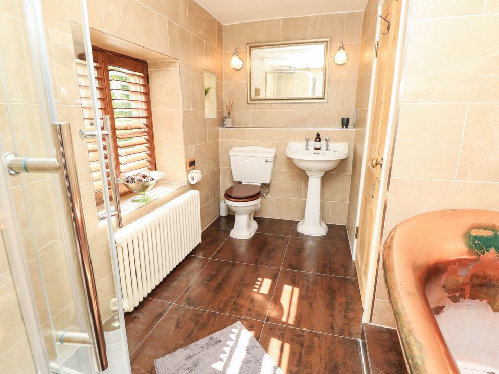 A bathroom with a shower, toilet, and sink at Beam Cottage in Warsash