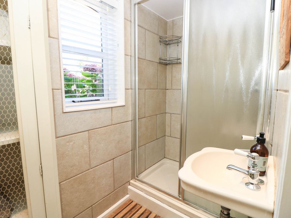 A bathroom with a shower and sink at Beam Cottage in Warsash
