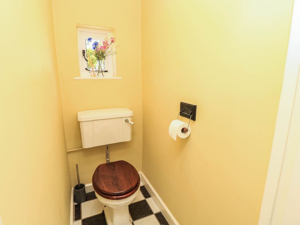 A bathroom featuring a toilet and a window at Beam Cottage in Warsash