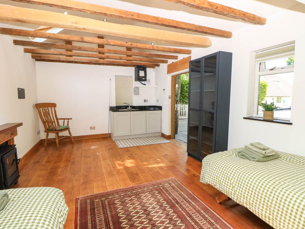 A kitchen with wooden beams and a counter at Beam Cottage in Warsash