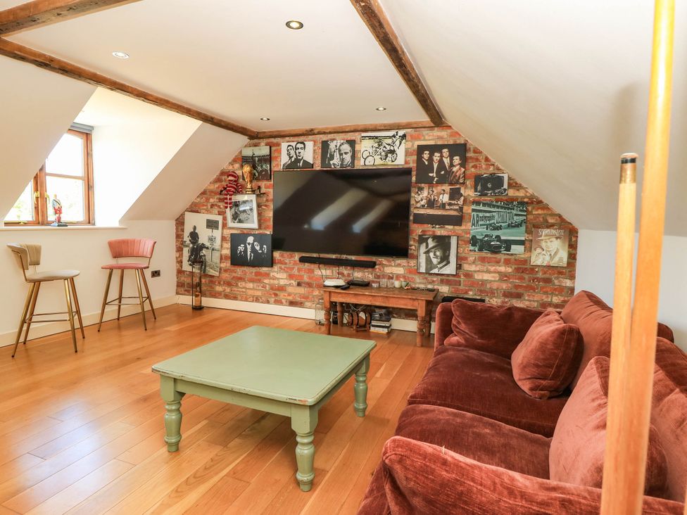 A living room with a television and sofa at Beam Cottage in Warsash