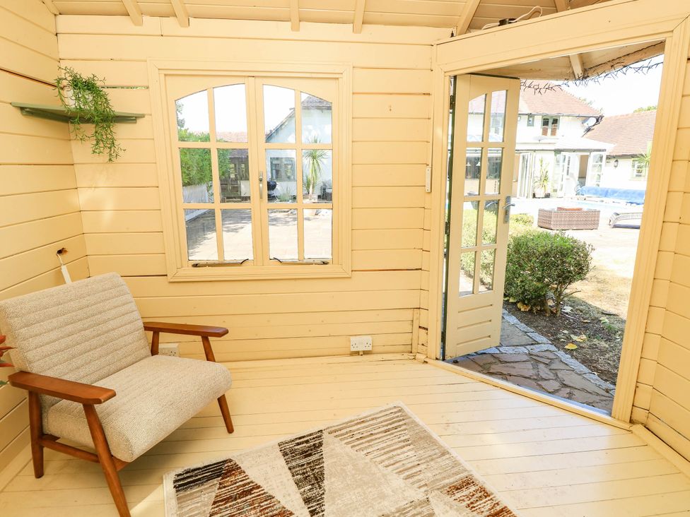 A snug with a chair and window at Beam Cottage in Warsash