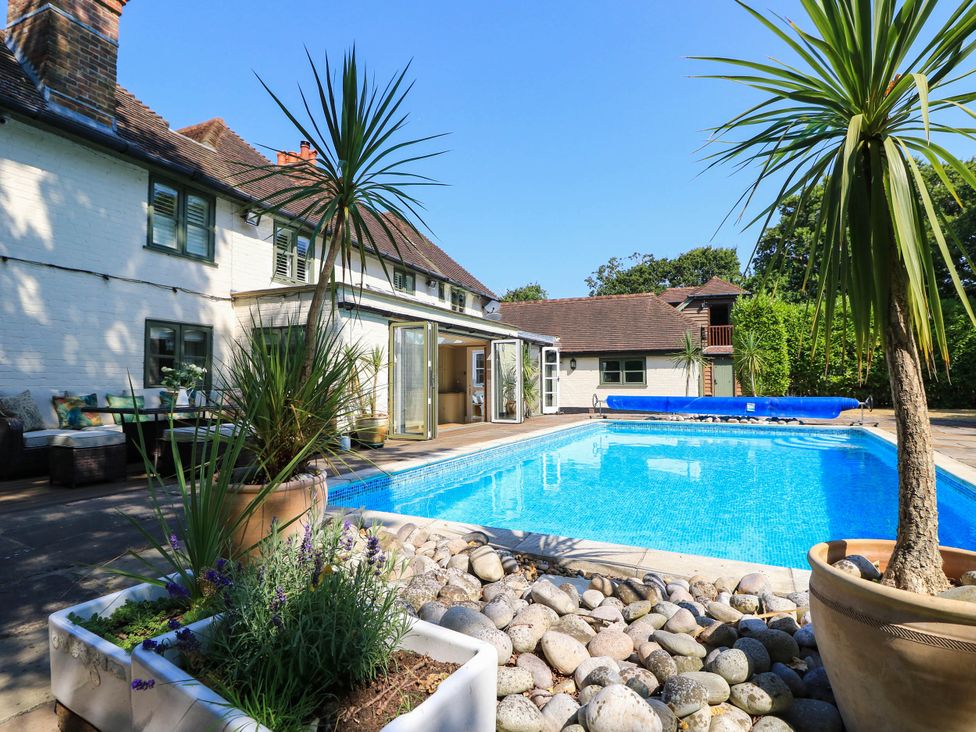A pool with deck and plants at Beam Cottage in Warsash