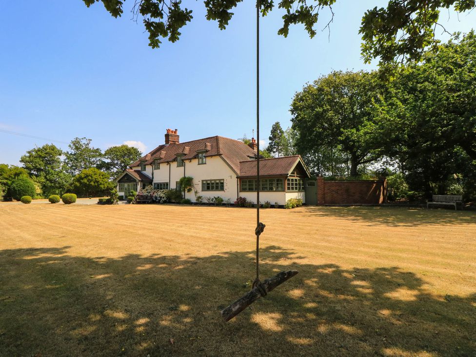 A house with a swing and lawn at Beam Cottage in Warsash