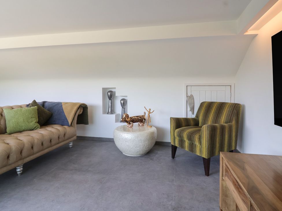 A living room with a sofa and an armchair at Number 7 in Bishop Sutton