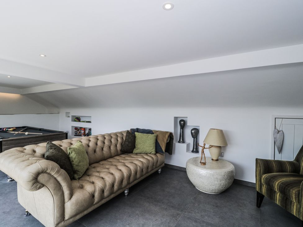 A snug with a sofa and armchair at Number 7 Bishop Sutton