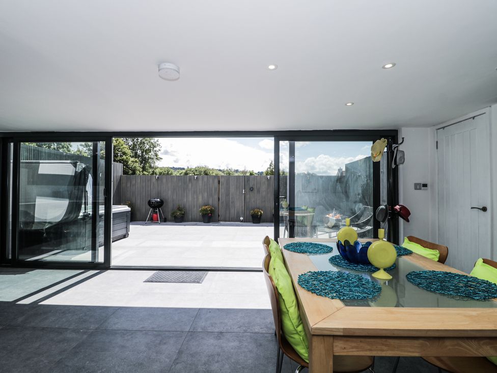 A dining room with a glass door leading to an outdoor area at Number 7 in Bishop Sutton