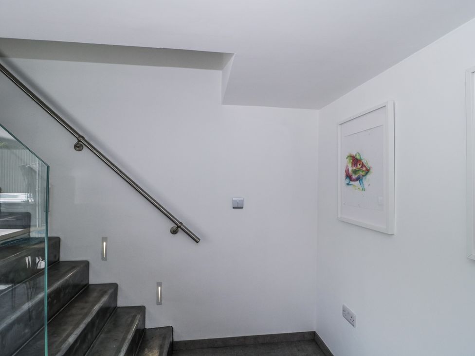 A staircase with railing and artwork on the wall at Number 7 in Bishop Sutton