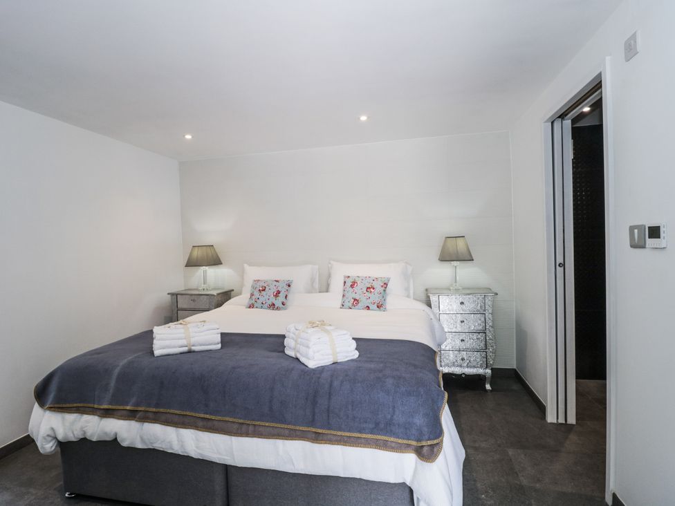 A bedroom with two beds and nightstands at Number 7 in Bishop Sutton