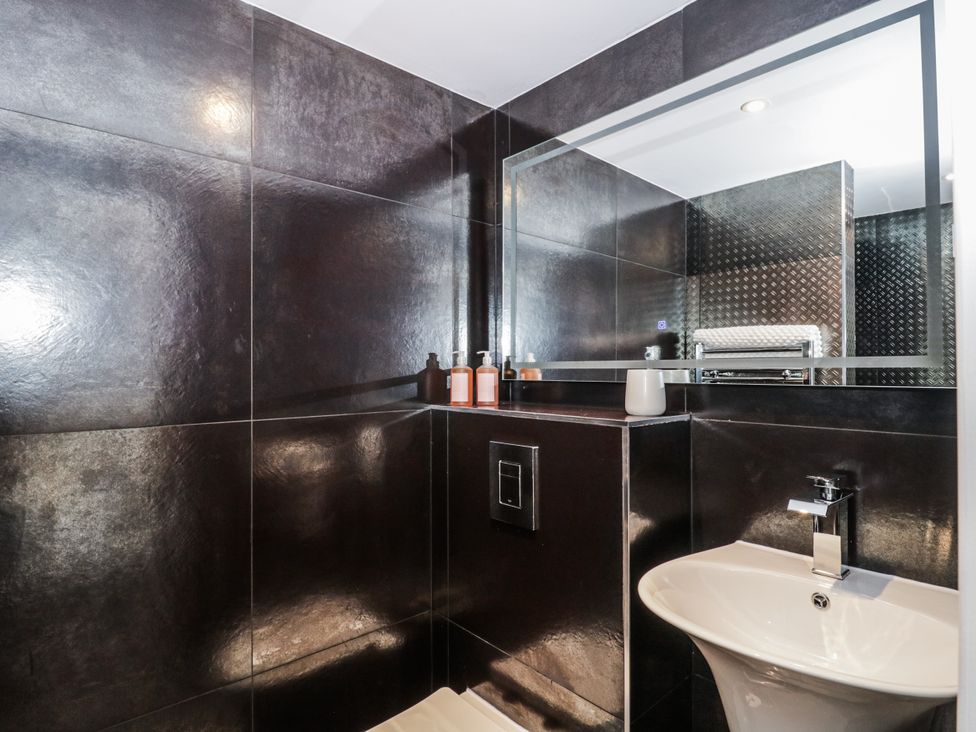 A bathroom with a sink and mirror at Number 7 in Bishop Sutton