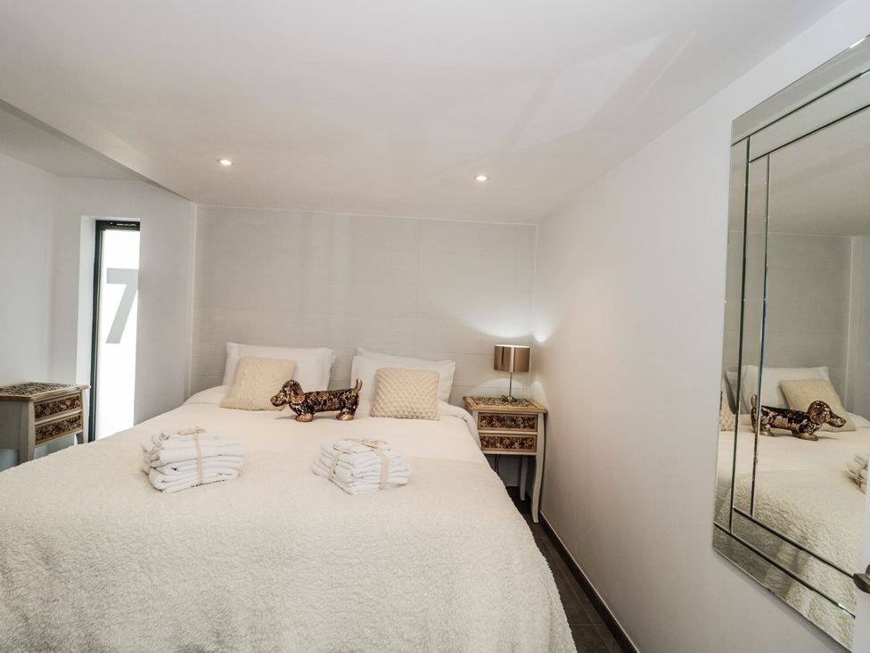 A bedroom with a bed and towels on top at Number 7 in Bishop Sutton