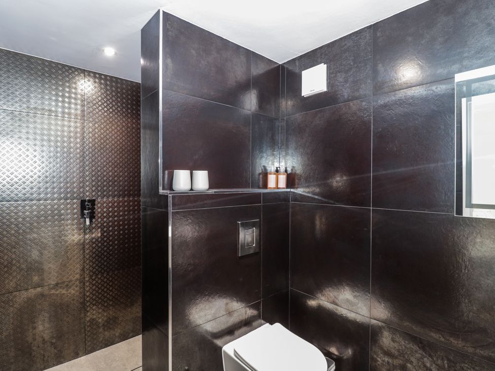 A bathroom with a toilet and shower at Number 7 in Bishop Sutton