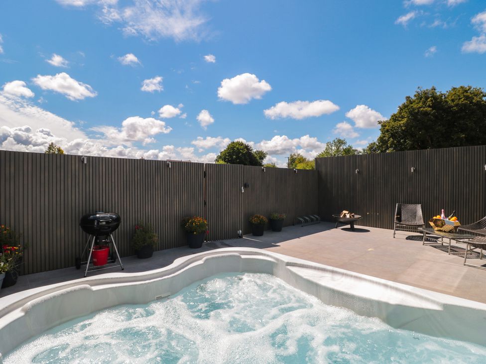 An outdoor area with a hot tub and grill at Number 7 in Bishop Sutton