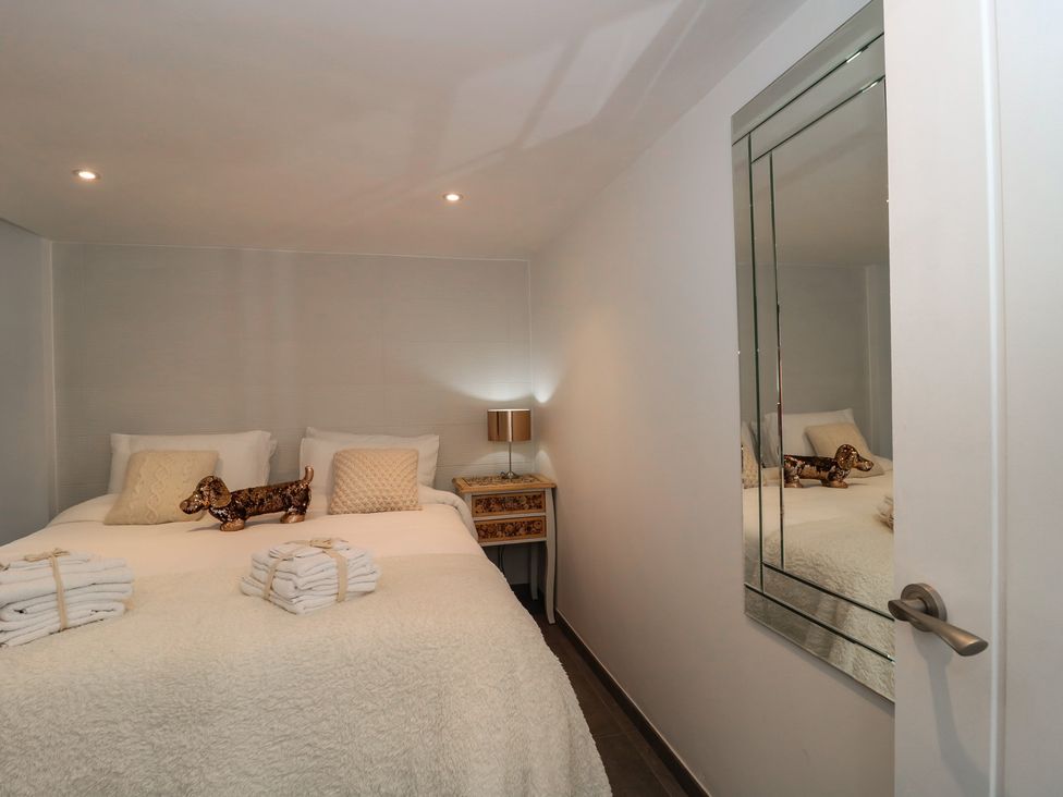 A bedroom with a bed, pillows and towels at Number 7 in Bishop Sutton