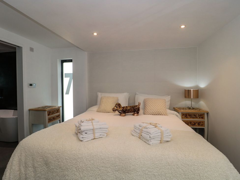 A bedroom with a bed and decorative items at Number 7 in Bishop Sutton