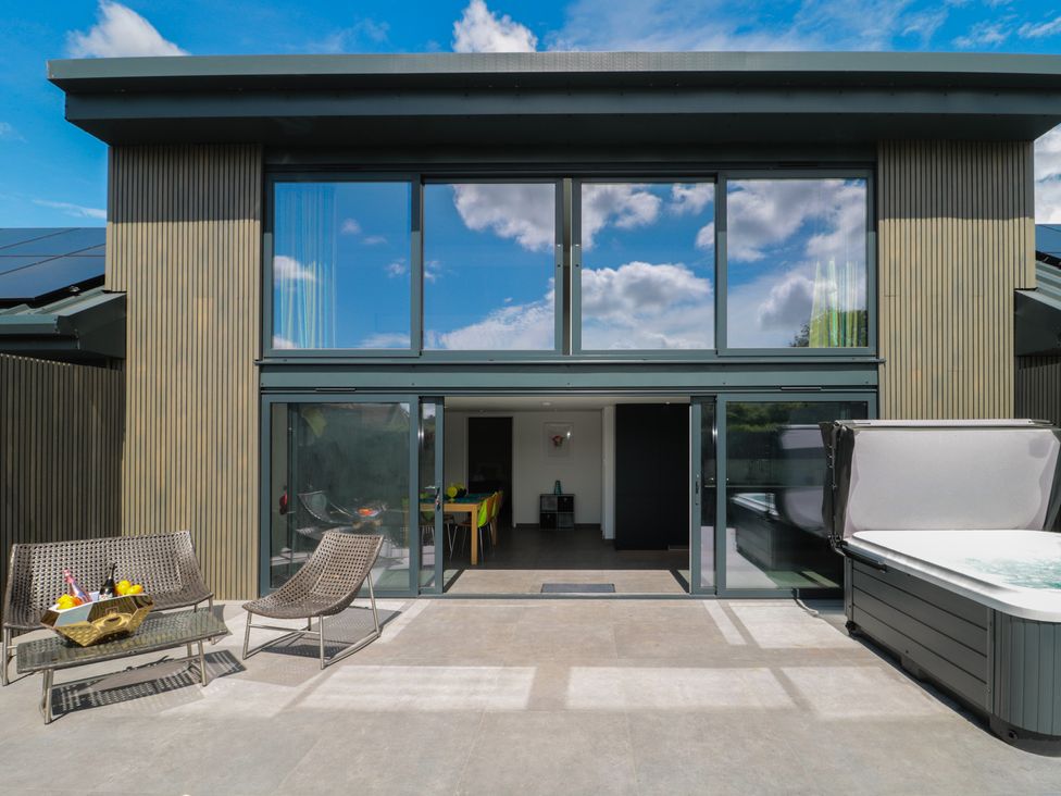An outdoor space with chairs and a pool at Number 7 in Bishop Sutton